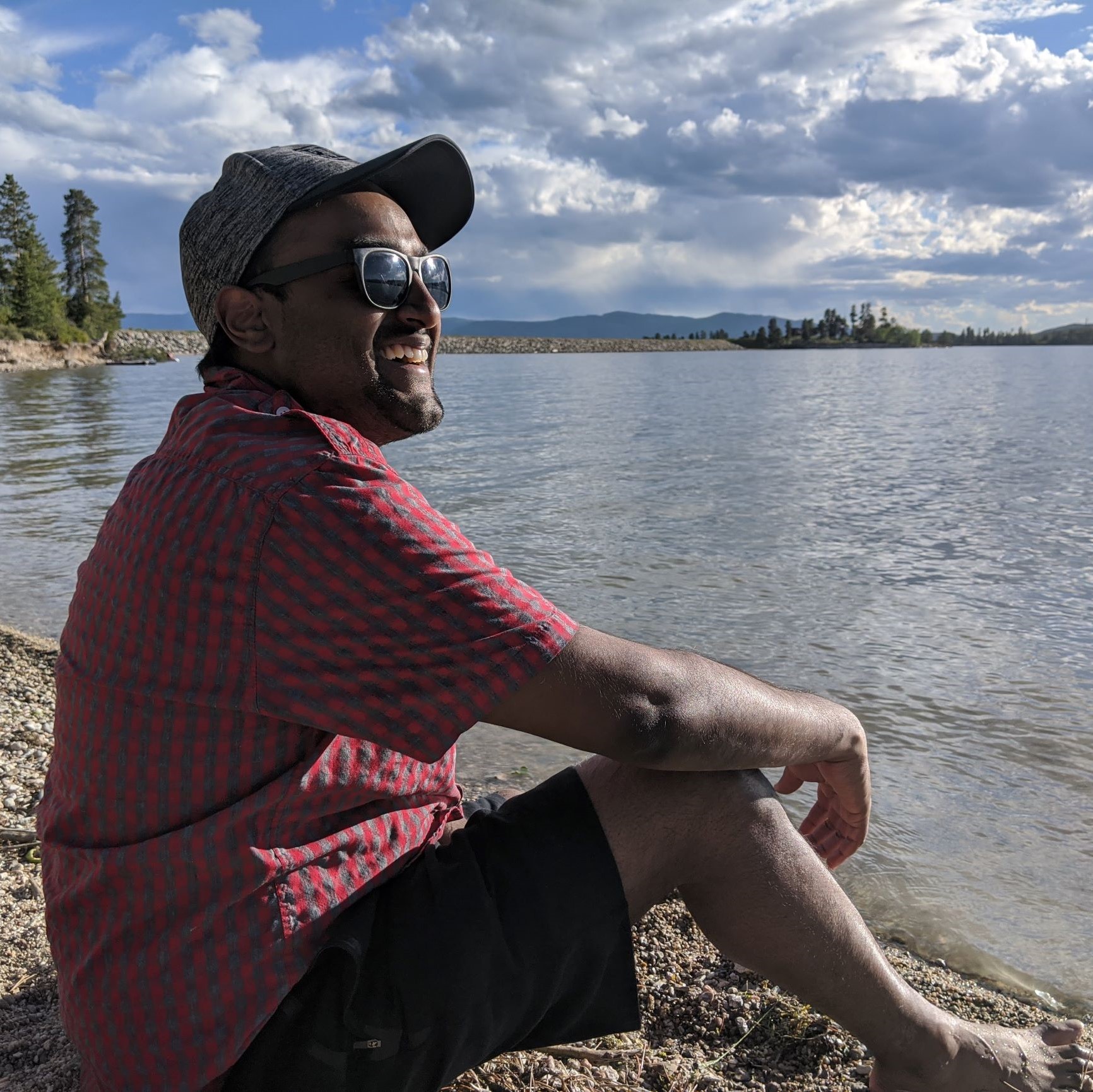 KJ smiling by a lake